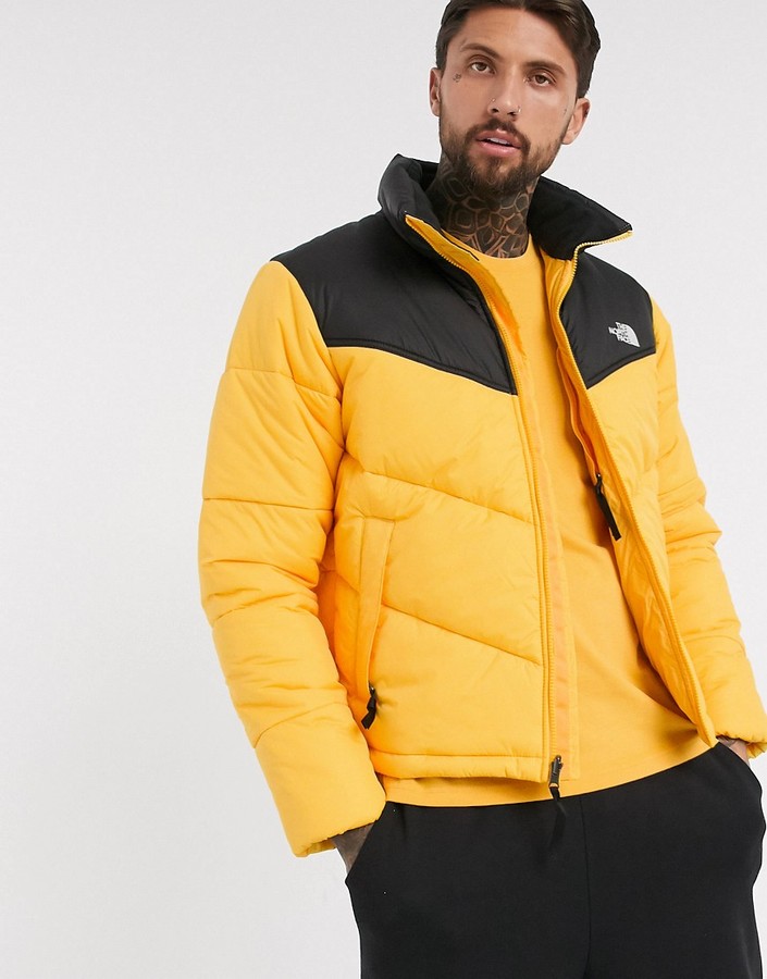 yellow and black north face puffer