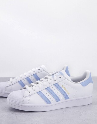 adidas Superstar trainers in white with light blue stripes - ShopStyle