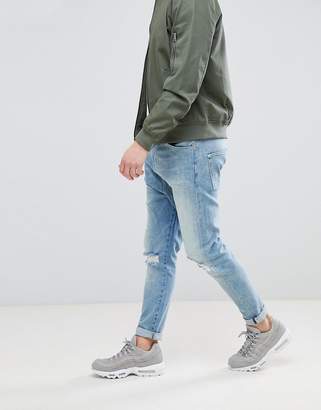 ASOS Design Drop Crotch Jeans In Mid Wash Blue With Rips