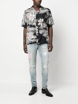 Thumbnail for your product : Amiri Tie Dye Core logo-embroidered distressed slim-cut jeans