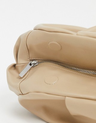 ASOS DESIGN oversized ruched clutch bag in beige - ShopStyle