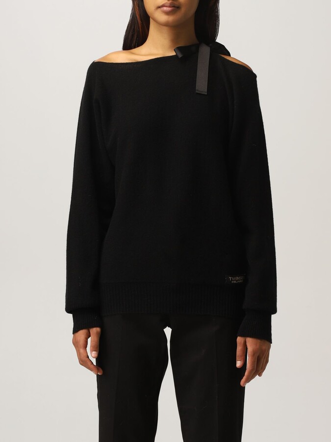 black sweater with bow on shoulder