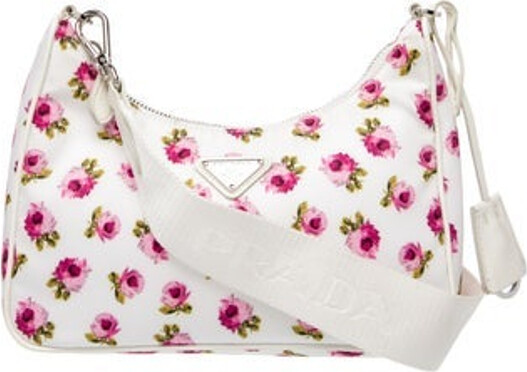 Prada Shoulder Bag Bianco Tessuto Floral Print Tessuto Nylon & Enameled Metal Triangle Silver-Tone Hardware Saffiano Leather Trim Chain-Link Handle & Single Adjustable Shoulder Strap Leather Trim Embellishment Logo Jacquard Lining Zip Closure at Top Includes Dust Bag Clochette & Coin Purses