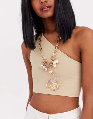 ASOS Design DESIGN statement necklace with pastel pearls and abstract pendant in gold tone