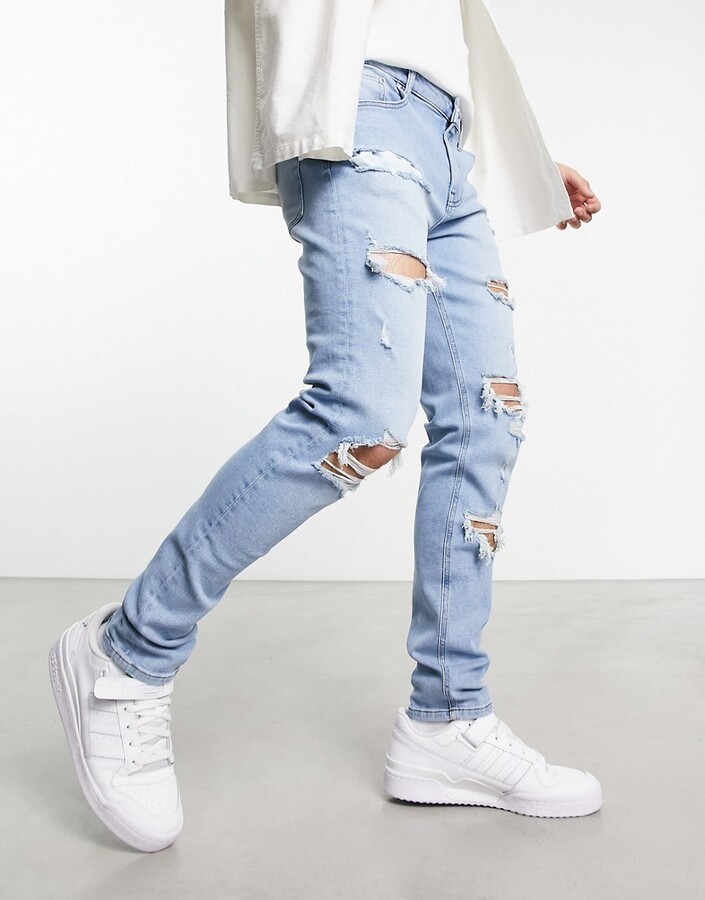 ASOS DESIGN skinny jeans with rips in light wash blue - ShopStyle