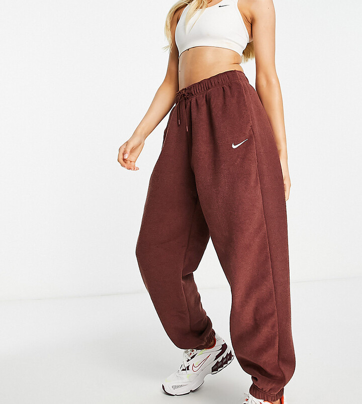 Nike Essentials Plush high-rise cuffed fleece sweatpants in bronze - BROWN  - ShopStyle Activewear Pants
