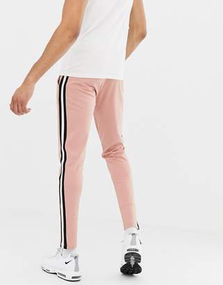 ASOS DESIGN tall skinny sweatpants in poly tricot with side stripe in pink