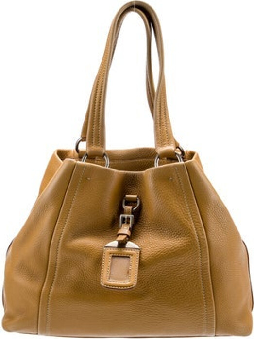 Prada Bucket Bag Brown Vitello Daino Leather Silver-Tone Hardware Rolled Handles & Dual Shoulder Straps Logo Jacquard Lining Buckle Closure at Front Unfortunately, due to restrictions, this item may not be eligible for shipping in all areas.