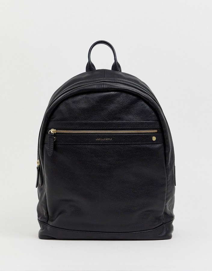black leather backpack with gold zippers