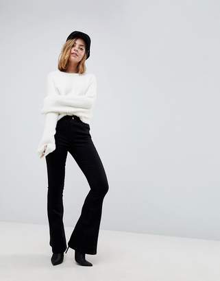ASOS Petite DESIGN Petite bell flare jeans in clean black with pressed crease