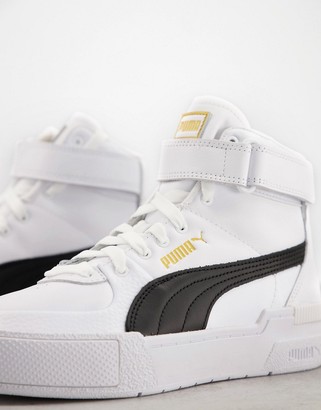 Puma Cali Sport Top Warm Up trainers in white and gold - ShopStyle