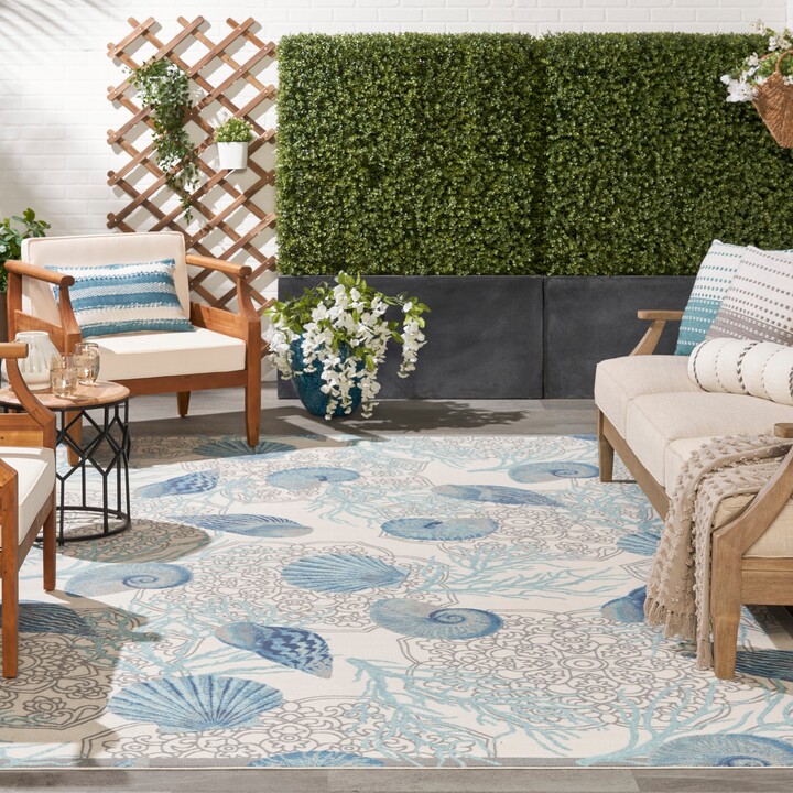 https://img.shopstyle-cdn.com/sim/13/67/1367e1d54c822301bc2ed799af0e5a7d_best/waverly-sun-shade-shore-thing-tropical-sea-shell-floral-indoor-outdoor-area-rug.jpg