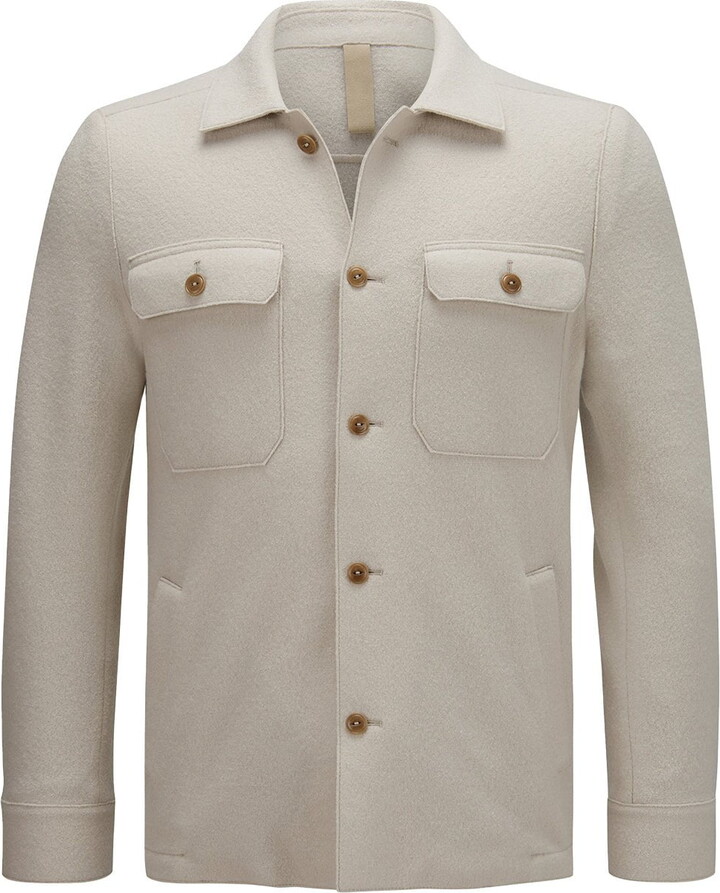 A $1,195 white peak-lapeled cotton jacket by Dolce & Gabbana tops