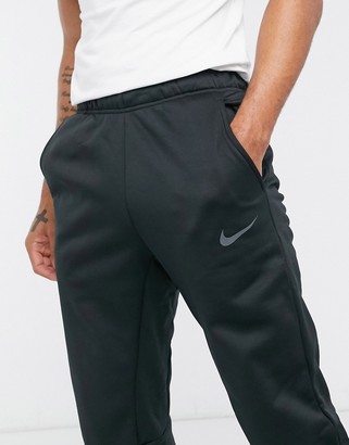 Nike Training Therma tapered joggers in black - ShopStyle Trousers