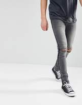 Thumbnail for your product : ASOS DESIGN super skinny jeans in washed black with side stripe and knee rips