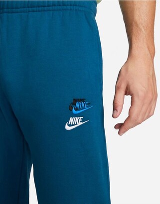 Nike Essentials fleece multi logo casual fit cuffed joggers in blue -  ShopStyle Trousers