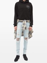 Thumbnail for your product : Amiri Distressed Printed-patch Skinny-leg Jeans - Blue