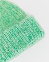 Thumbnail for your product : ASOS DESIGN fluffy two tone beanie hat in green