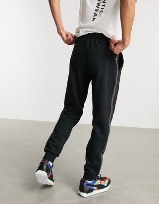 Puma sweatpants in black with gold taping - ShopStyle Activewear Pants