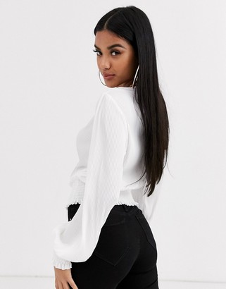 ASOS DESIGN plisse wrap top with shirred cuff and waist in ivory