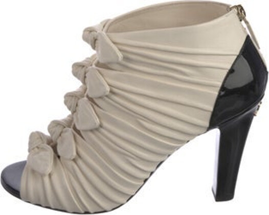 Chanel Paris-Hamburg Ankle Boots From the Pre-Fall 2018 Collection by Karl Lagerfeld Neutrals Lambskin Interlocking CC Logo Peep-Toes with Bow Accents Exposed Zip Closure at Sides Includes Box & Dust Bag