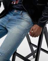 Thumbnail for your product : ASOS DESIGN Super Skinny Jeans In Vintage Mid Wash Blue With Rip And Repair Detail