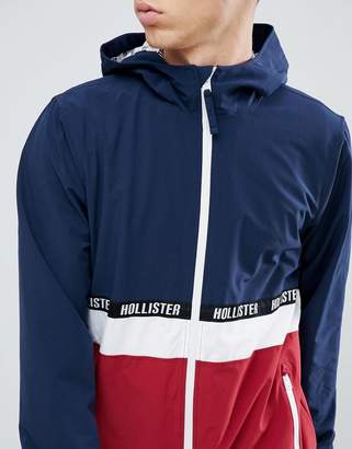 Hollister lightweight hooded jacket colourbock taping and seagull logo in navy/red