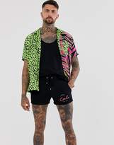 Thumbnail for your product : ASOS Design DESIGN jersey skinny shorts in shorter length with text print