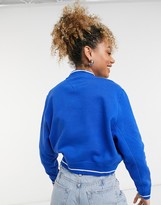 Thumbnail for your product : Tommy Jeans V neck front logo cropped sweatshirt in blue