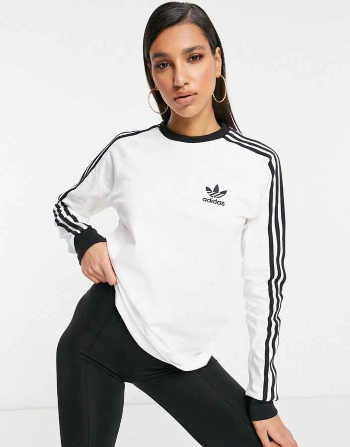 adidas adicolor three stripe long sleeve t-shirt in white - ShopStyle Tops