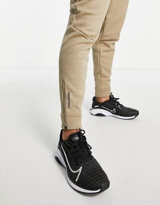 Nike Training Nike Pro Training Therma-FIT Sphere joggers in stone -  ShopStyle Trousers