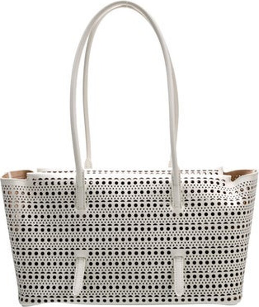 Alaia Shoulder Bag Leather Polka Dot Print Gold-Tone Hardware Dual Shoulder Straps Lasercut Accents Suede Lining Zip Closure at Top Protective Feet at Base Includes Coin Purses Unfortunately, due to restrictions, this item may not be eligible for shipping in all areas.