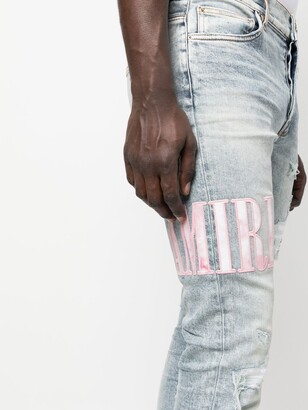 Amiri Tie Dye Core logo-embroidered distressed slim-cut jeans