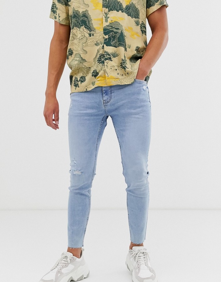 Bershka skinny jeans with knee rip in light blue - ShopStyle