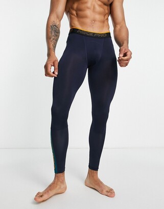 Nike Training Nike Pro Training Dri-FIT Swoosh leggings in navy and orange  - ShopStyle Trousers