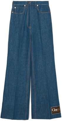 Gucci Washed denim flare pant with label - ShopStyle Jeans
