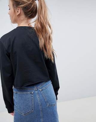 ASOS Design DESIGN sweatshirt with floral embroidery in washed black