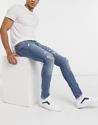 Jack and Jones Intelligence Liam skinny jeans with rips in blue - ShopStyle