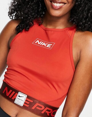 Nike Training Nike Pro Training GRX cropped logo tank in dark orange -  ShopStyle Activewear Tops