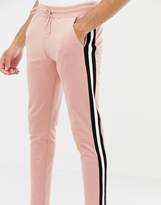 Thumbnail for your product : ASOS DESIGN tall skinny sweatpants in poly tricot with side stripe in pink