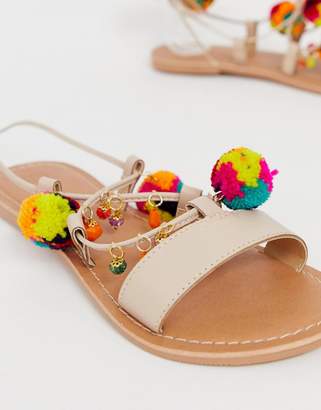 ASOS Design DESIGN Fun Fair pom pom leather tie leg flat sandals-Beige