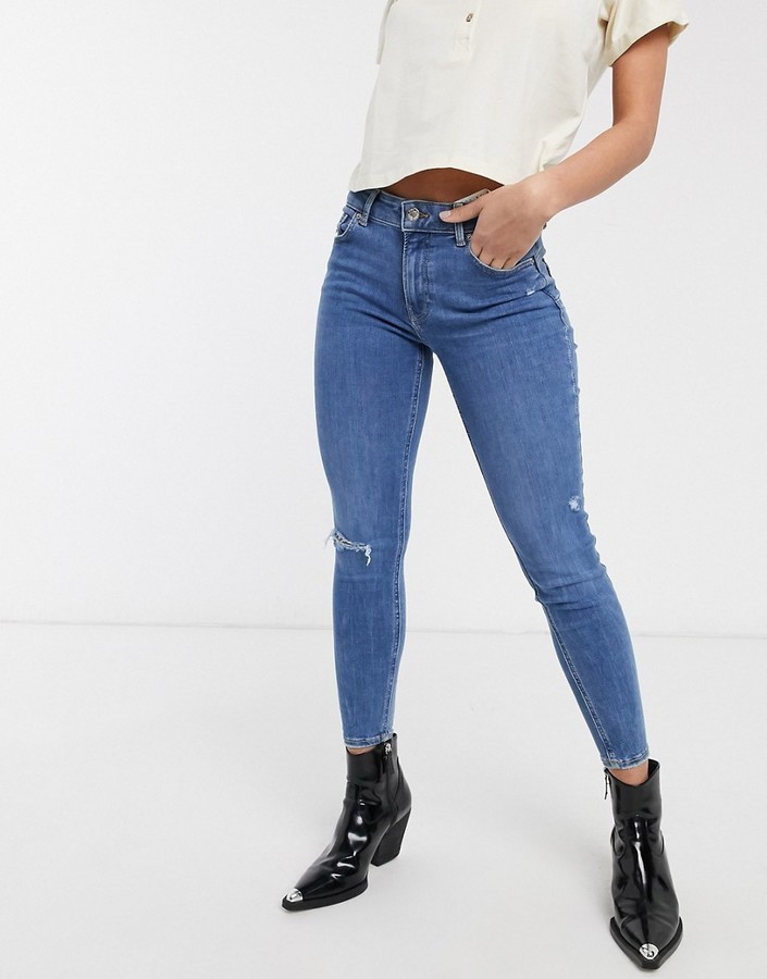 Bershka skinny push up jean in mid blue with knee rip - ShopStyle