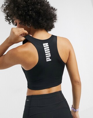 Puma Training active essentials sports bra in black with reflective logo -  ShopStyle