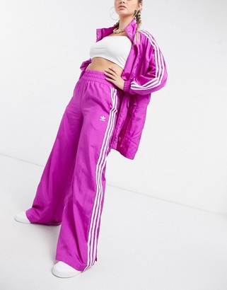 black adidas pants with pink stripes