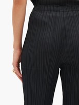 Thumbnail for your product : Pleats Please Issey Miyake High-rise Technical-pleated Tapered Trousers - Black