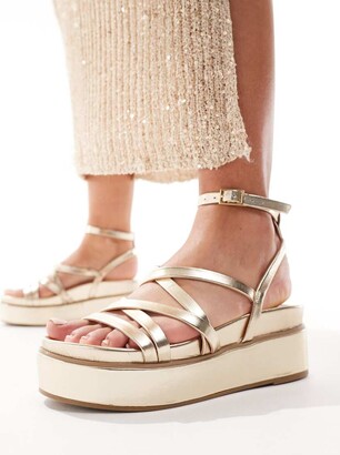 ASOS DESIGN Taurus strappy flatform sandals in gold ShopStyle