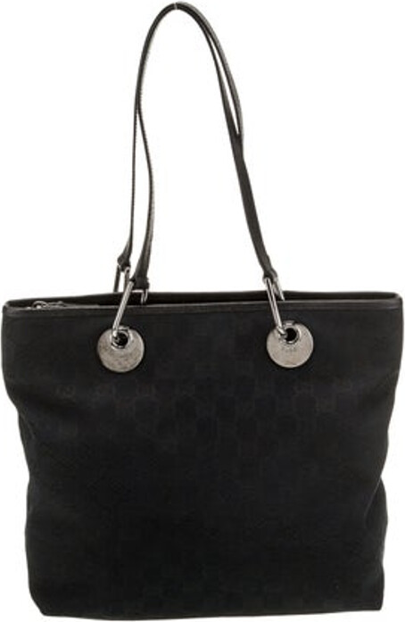 Gucci Tote Black Canvas GG Canvas Silver-Tone Hardware Leather Trim Dual Shoulder Straps Leather Trim Embellishment Canvas Lining & Dual Interior Pockets Zip Closure at Top Protective Feet at Base