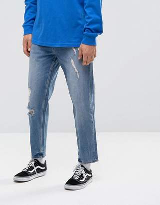 ASOS Design Skater Jeans In Mid Wash Blue With Abrasions