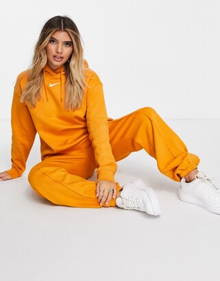 Nike mini swoosh oversized joggers in orange - ShopStyle