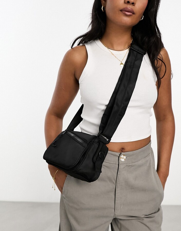 ASOS DESIGN leather curved base crossbody sling bag with contrast stitch in  black